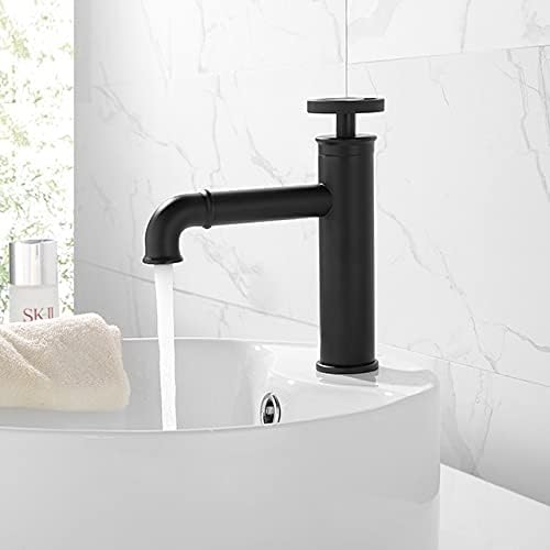 Matte black basin mixer tap fitted on wash basin in bathroom interior, modern black bathroom mixer look