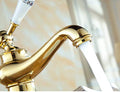 Golden tap for wash basin with single lever control, angled view of brass basin mixer tap