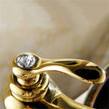 InArt wash basin mixer tap installed on countertop, modern bathroom interior with white gold brass tap