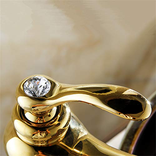 InArt wash basin mixer tap installed on countertop, modern bathroom interior with white gold brass tap