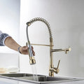 Pull out sink mixer tap close-up of single lever handle and smooth golden finish on brass body