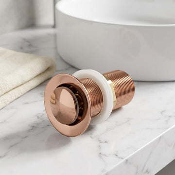 Rose gold pop-up waste coupling for wash basin with half-cap top view