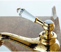 InArt brass tap for wash basin with smooth single lever handle, close-up of gold finish