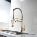 Pull out kitchen spray tap with single lever control and gooseneck spout in gold finish, angled view