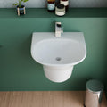 Wall hung wash basin in glossy white ceramic, rectangular compact design, angled view for modern bathrooms