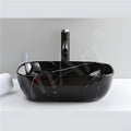 Black ceramic table top wash basin with granite counter look for bathroom or dining hall, premium sanitaryware
