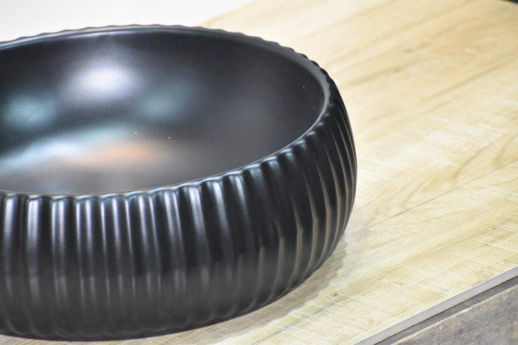 Matte black table top wash basin in modern bathroom interior, premium ceramic round basin for washroom counter