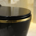 InArt ceramic wall mounted commode close-up showing rimless bowl design and smooth black gold glaze