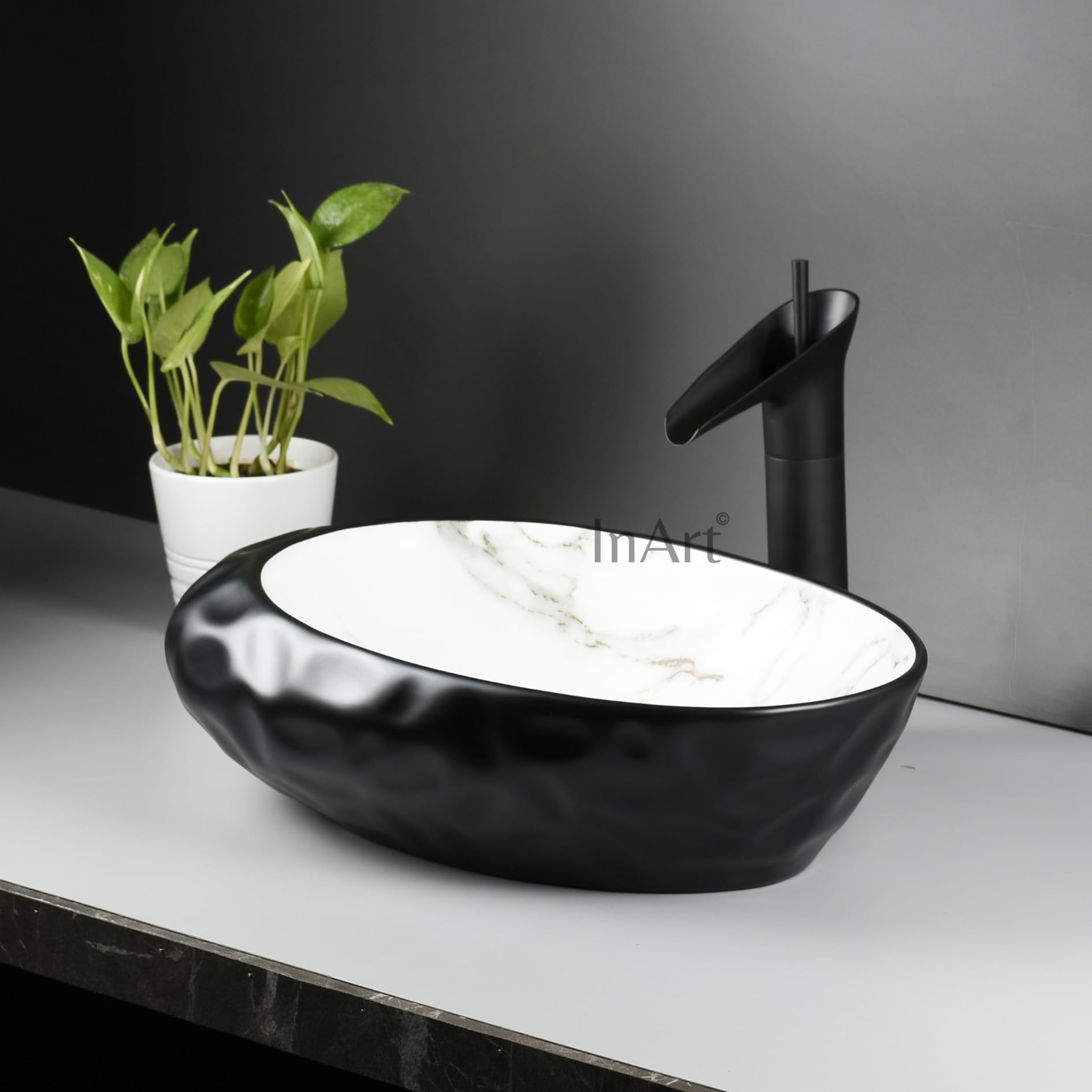 Modern washing basin design by InArt, oval ceramic table top wash basin in matt black marble, top view