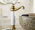 Gold and white gold basin mixer tap, single lever deck mount, angled view for modern bathroom basin