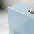 Close-up of soft close toilet seat and lid on light blue one piece western commode for modern bathroom