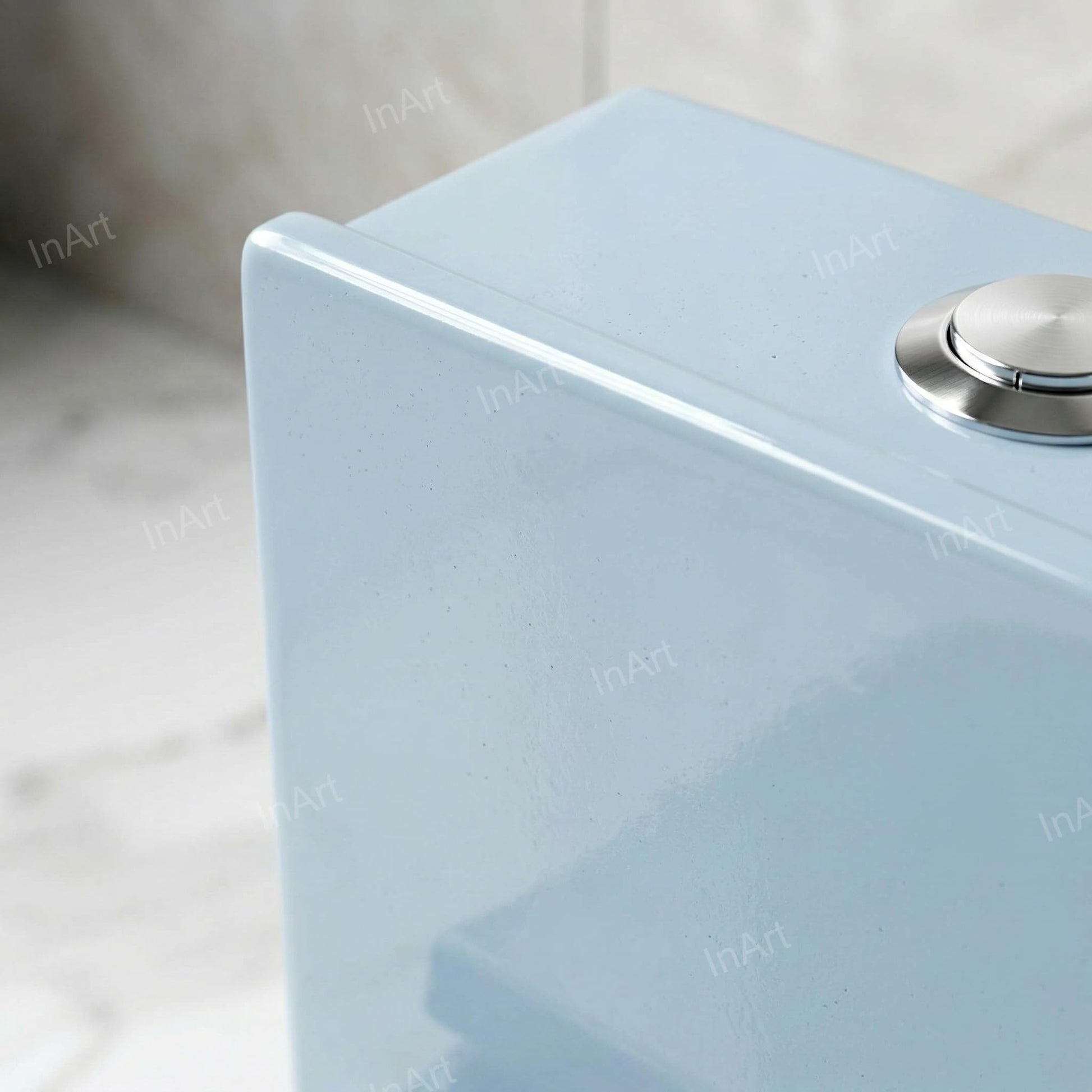 Close-up of soft close toilet seat and lid on light blue one piece western commode for modern bathroom