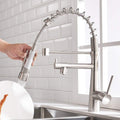 Kitchen taps and mixers detail of 360° swivel gooseneck spout and pull-down hose in brushed chrome