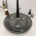 Black tempered glass wash basin table top installed on vanity, modern bathroom interior with tap