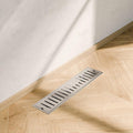 Modern bathroom floor drain channel in silver stainless steel, 18x4 inch rectangular jali side angle