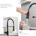 Sink tap flexible hose detail on brass kitchen sink mixer tap, pull-down sprayer extended for rinsing