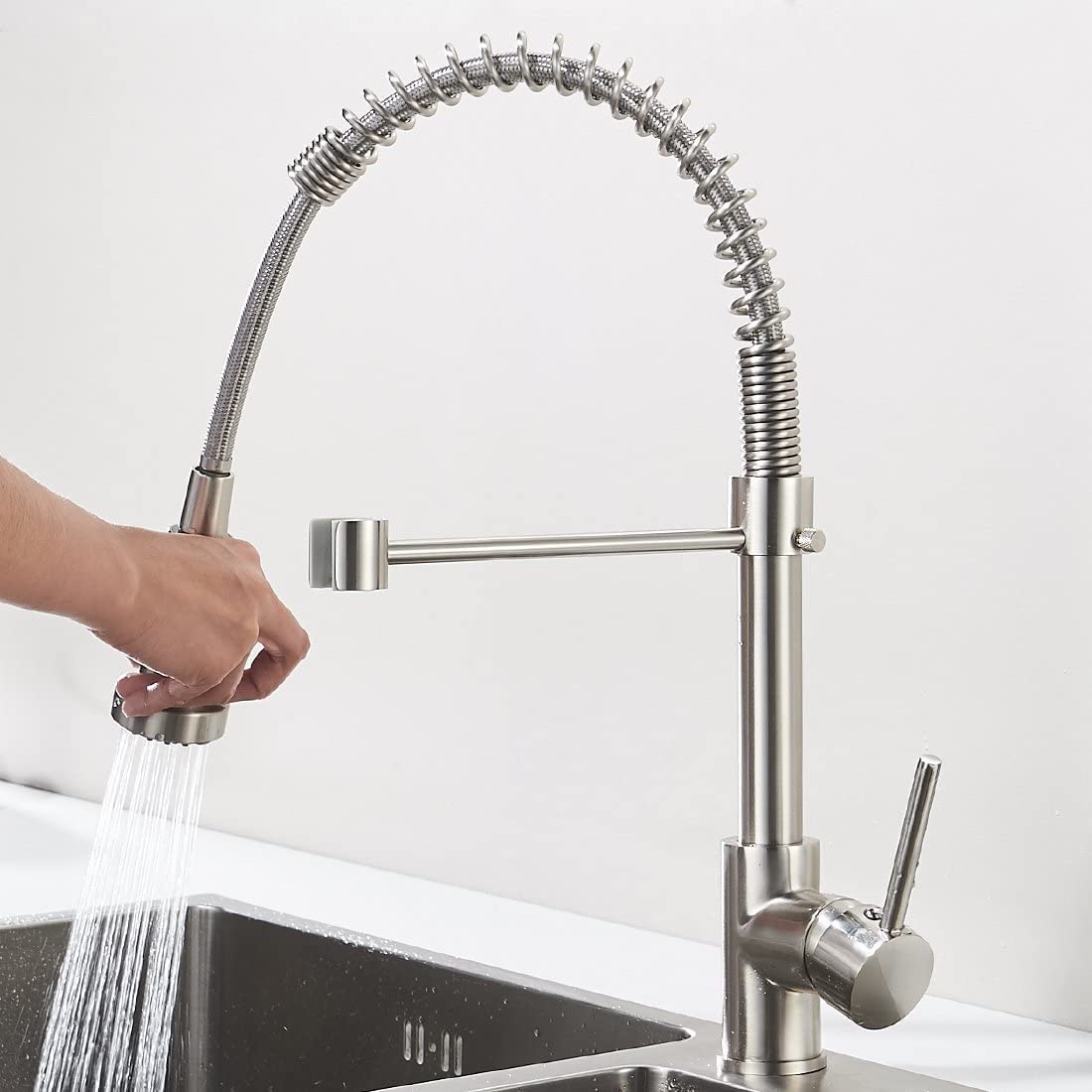 Stainless steel sink mixer tap with 360° swivel spout and single lever control, three-quarter angle view