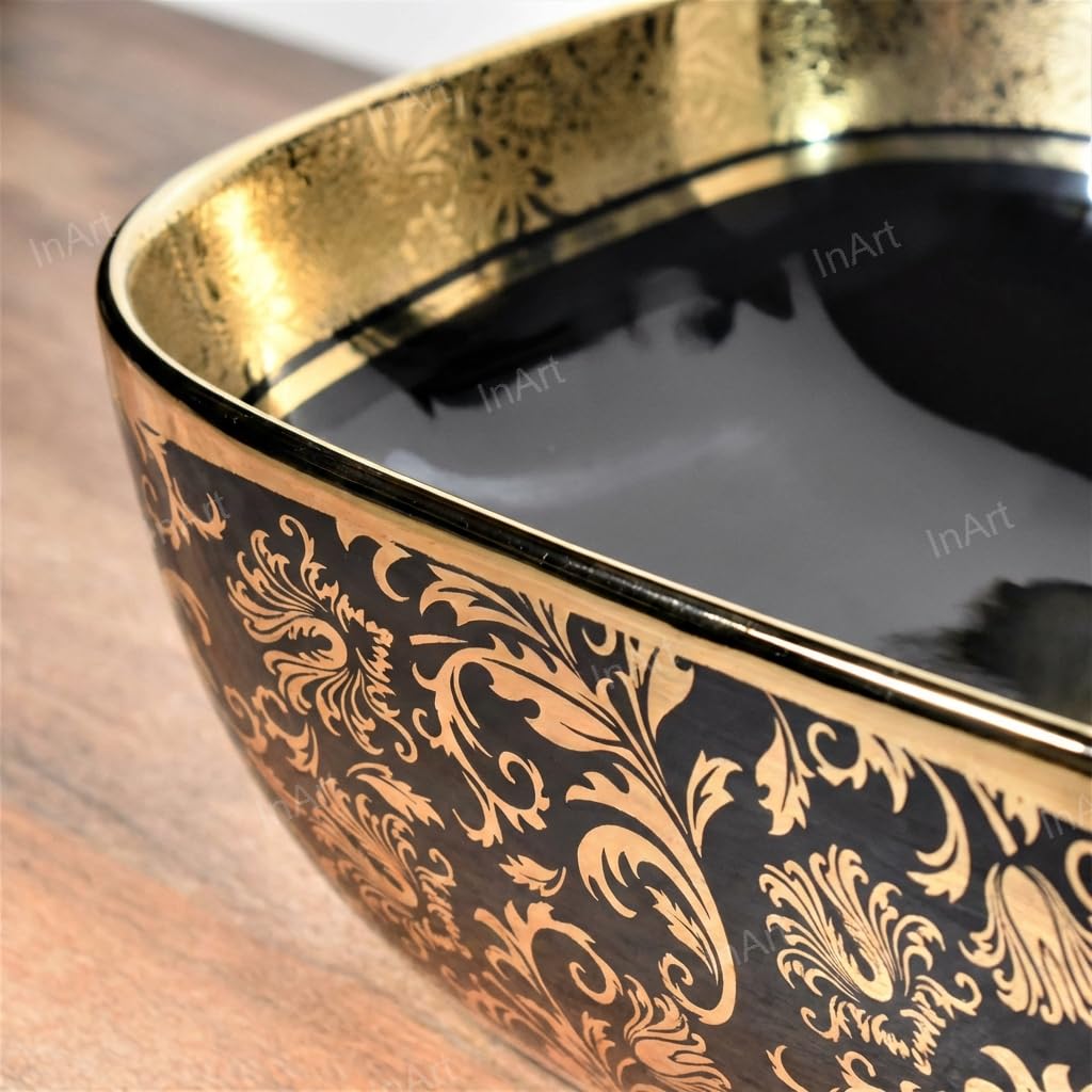 Close-up of glossy black and gold ceramic wash basin countertop showing smooth glaze and oval curve