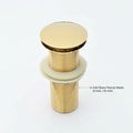 Gold brass waste coupling installed in bathroom wash basin, pop-up drain kit for clean and modern interior