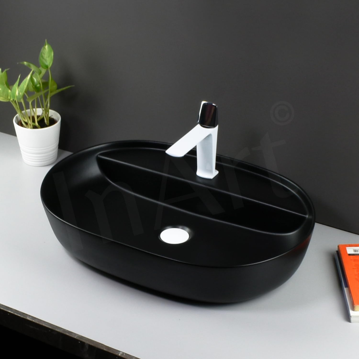 InArt matte black table top wash basin styled in a modern bathroom interior with tap and counter, premium look