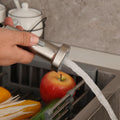 Kitchen sink tap with sprayer showing flexible pull-down hose and 360° swinging spout, chrome finish