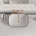 InArt table top wash basin in bathroom interior, rose gold rectangular ceramic basin on counter with tap