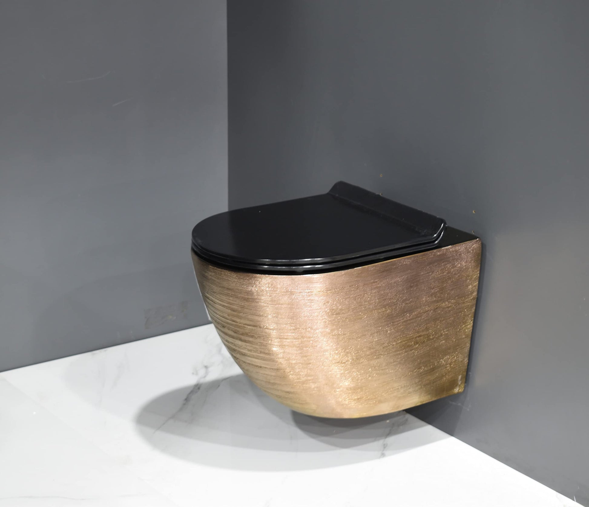 Modern bathroom wall hung commode design, InArt rimless ceramic EWC rose gold finish shown in 3/4 angle