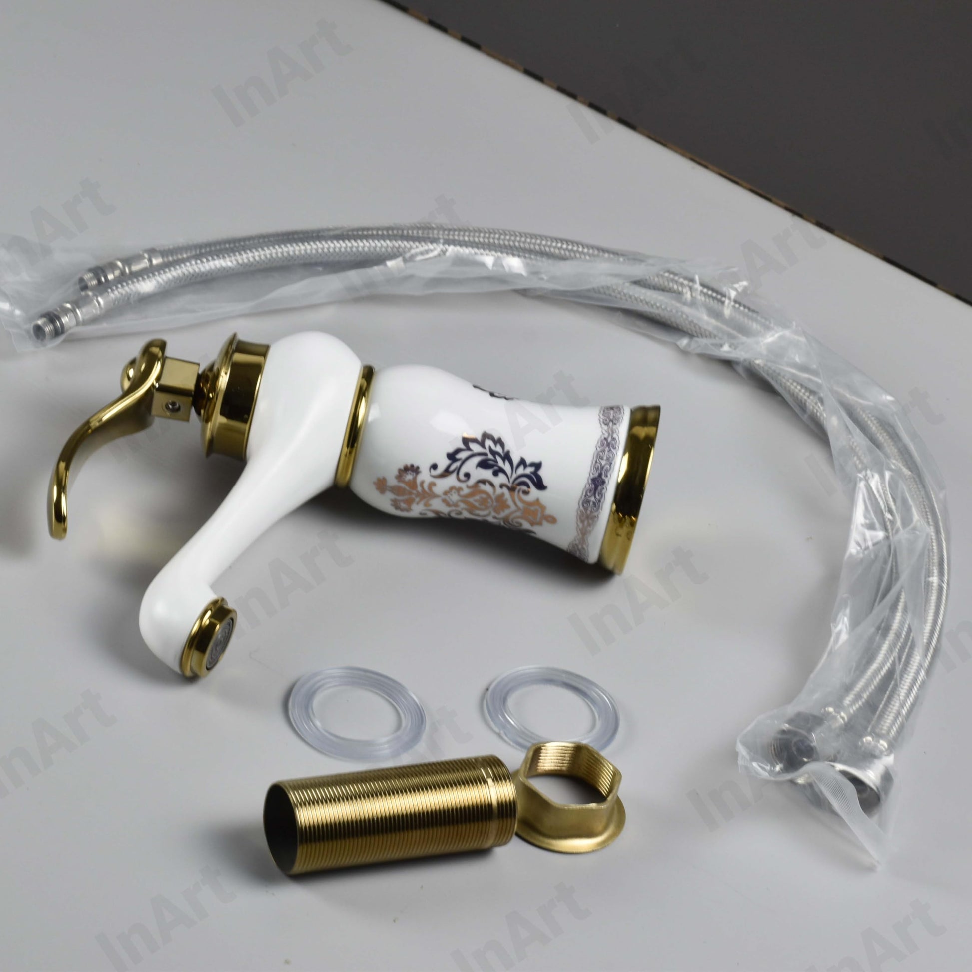 Close-up of InArt single lever basin mixer handle and ceramic cartridge, premium gold white glossy finish