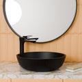 Modern wash basin design round table top basin in black satin finish, side angle view for bathroom
