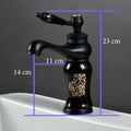Glossy black single lever basin mixer tap for wash basin, deck mount angle view with waterfall outlet