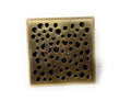 InArt bronze finish brass floor drain jali, side angle showing 4 inch pipe fit and sturdy build