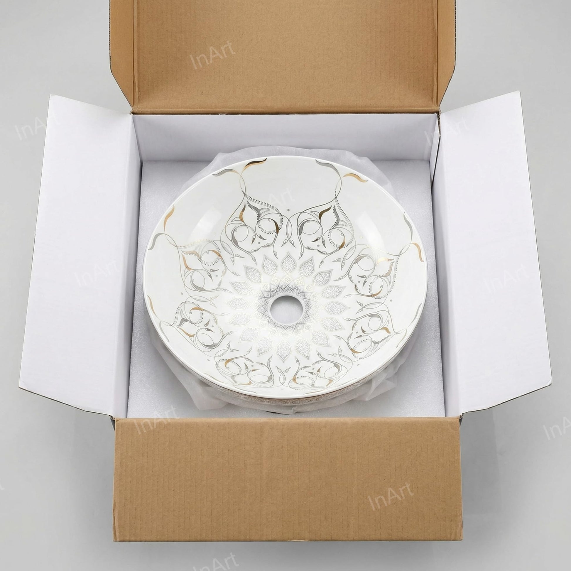 InArt ceramic table top wash basin in bathroom interior, white and gold round basin on table with wash basin