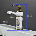 Gold white wash basin mixer tap, single lever waterfall spout, angled view for modern bathroom basin design