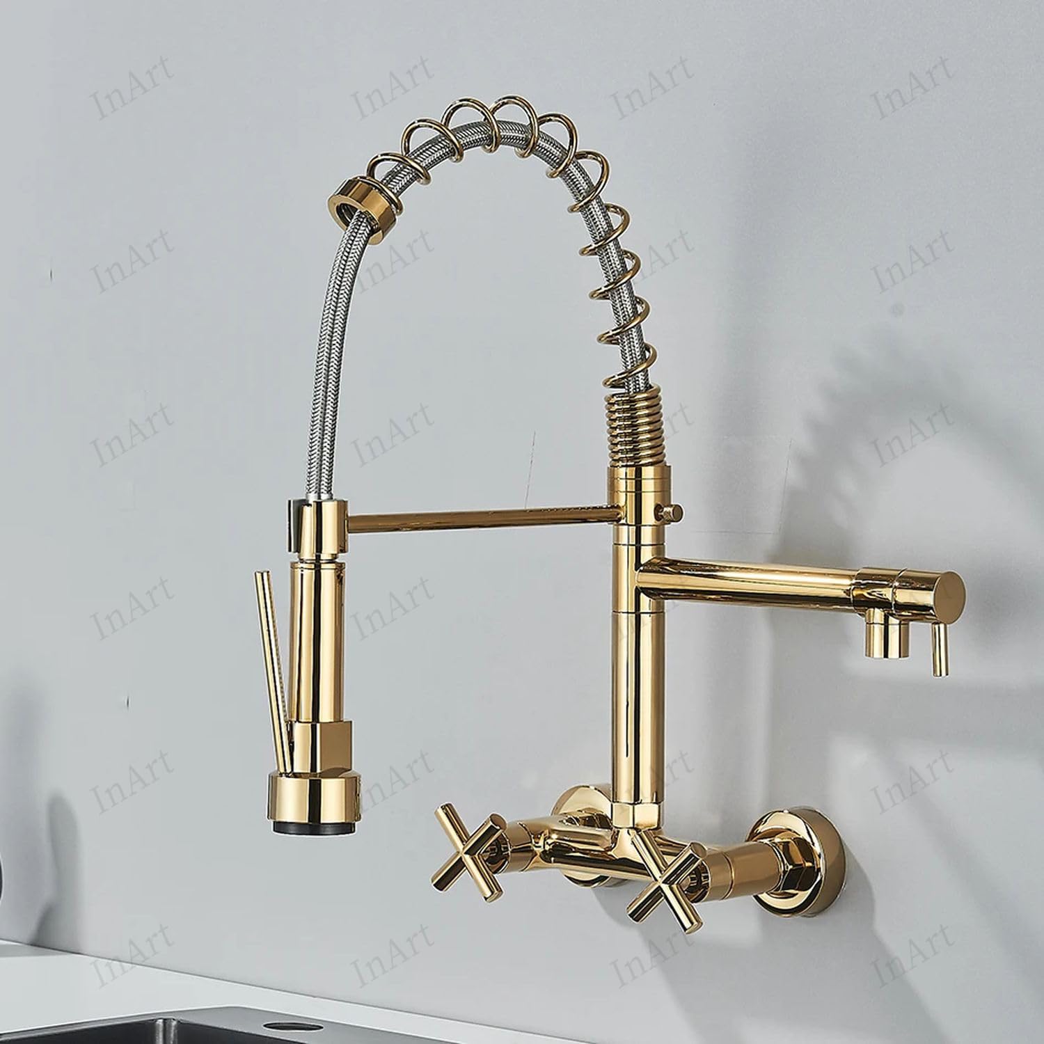 Close-up of gold pull down kitchen faucet spray head with retractable hose and tap with spray function