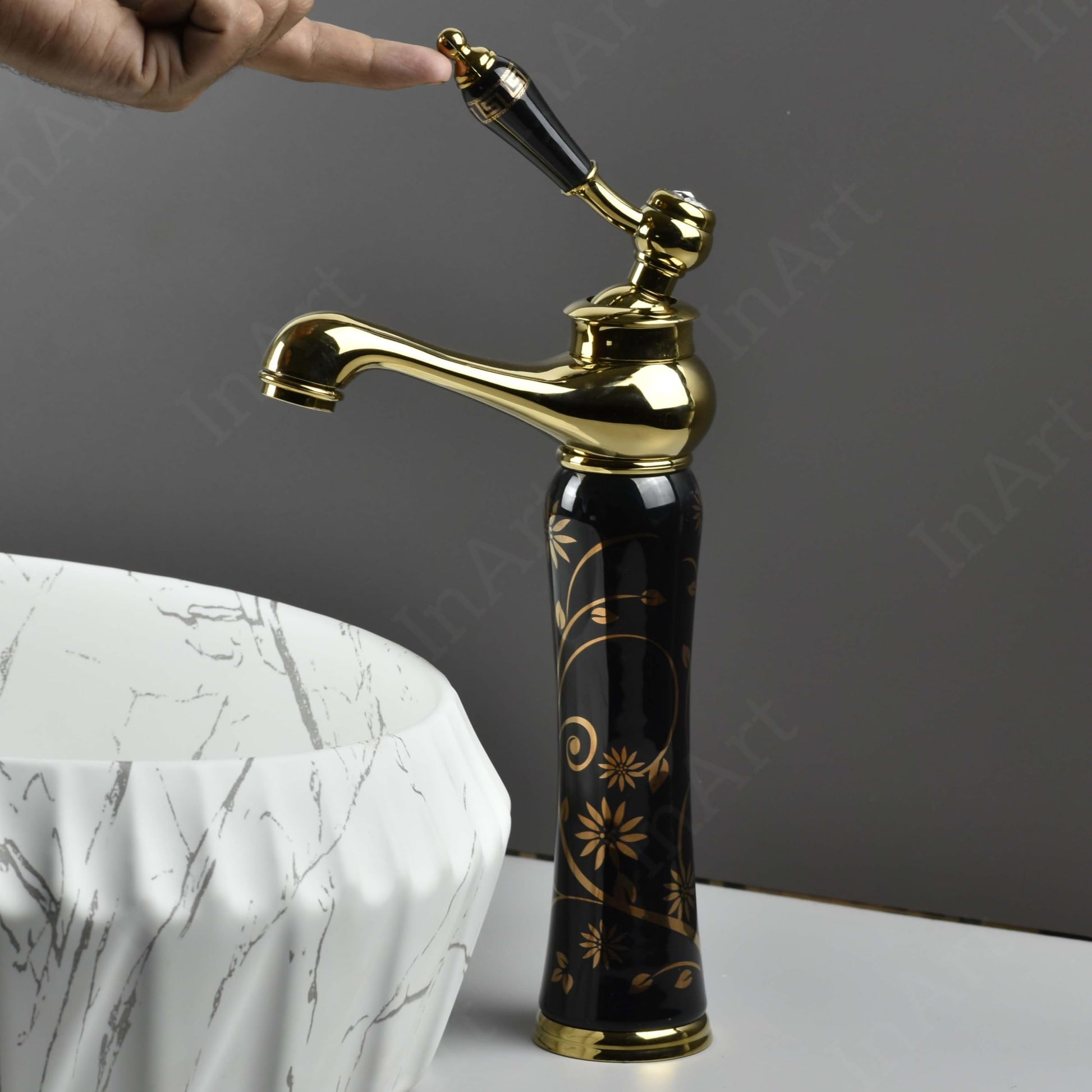 Designer waterfall wash basin taps in antique black gold, top view showing wide spout and smooth flow