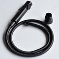 Close-up of InArt matte black health faucet gun lever, ABS bidet spray head for bathroom hygiene