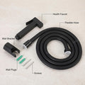 Black health faucet set for toilet, complete kit with jet spray gun, hose pipe and holder on white background
