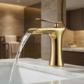 InArt single lever basin mixer in golden brass with waterfall spout, front view bathroom tap