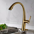 Gold stainless steel single lever sink mixer tap, side angle view with 360 degree swinging spout