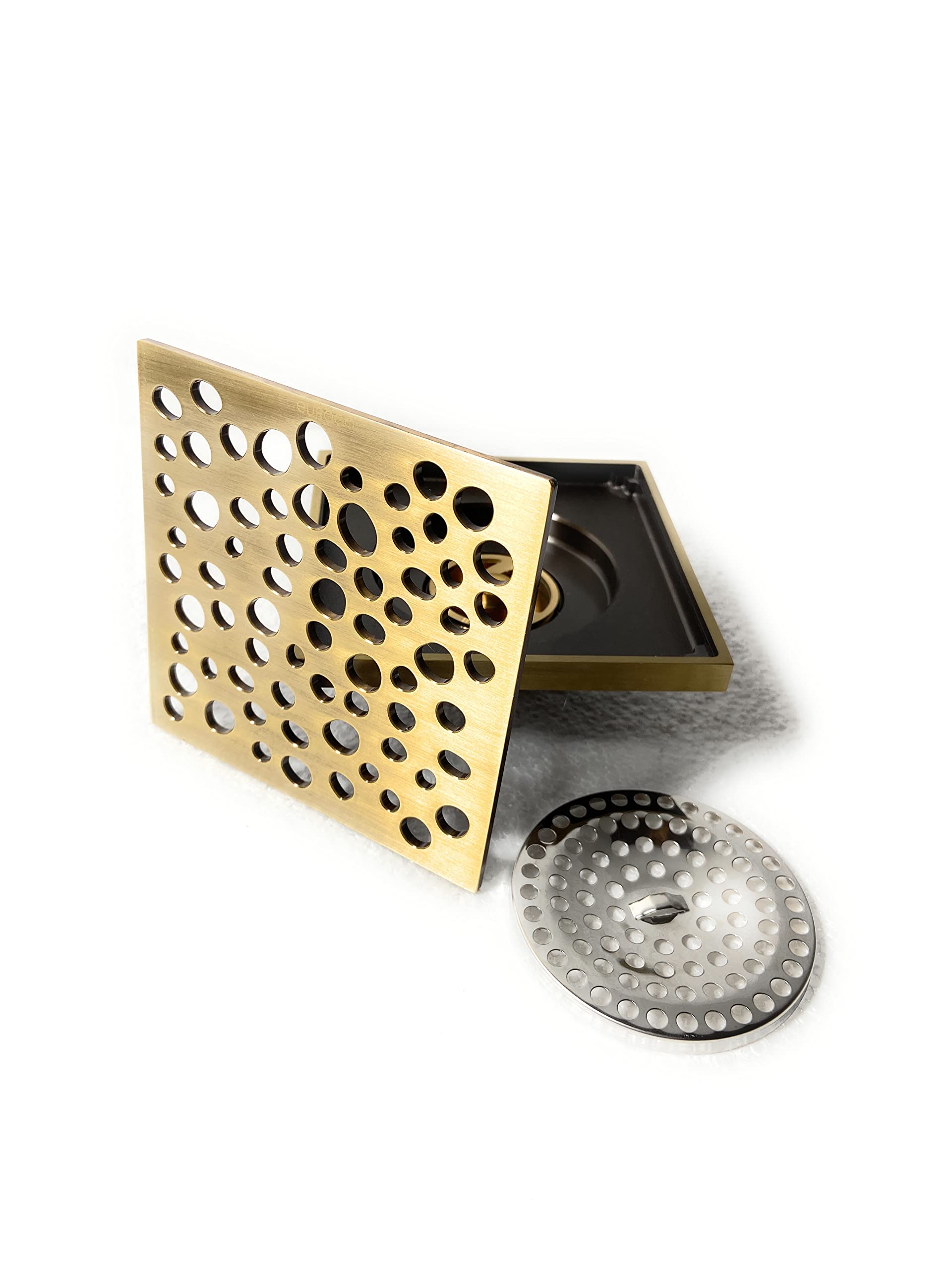 Installed InArt antique brass floor drain jali in bathroom floor, square bronze finish with odour control