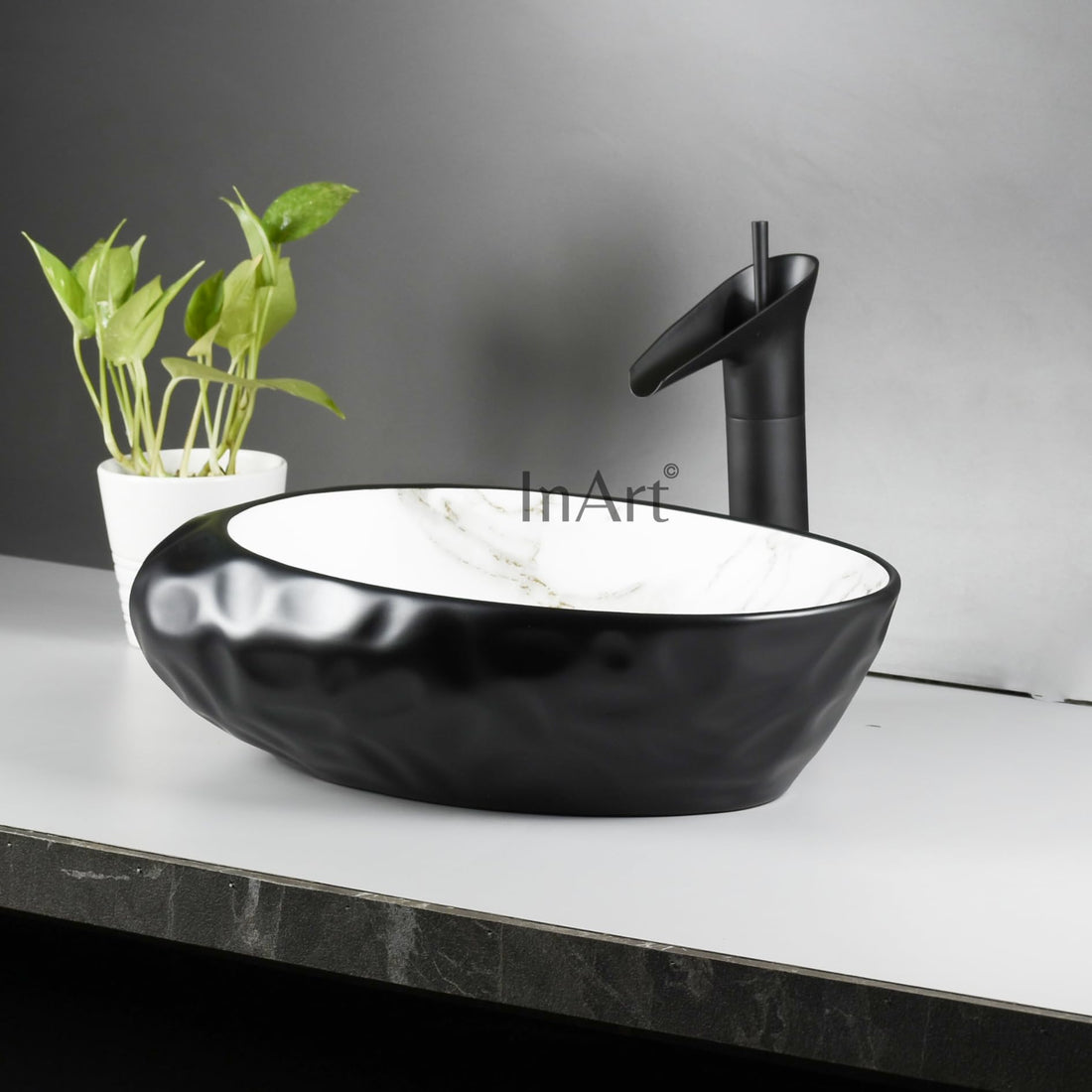 InArt contemporary wash basin, matte ceramic oval table top basin in black and white marble finish
