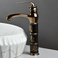 Modern wash basin mixer single lever tap with high arc waterfall spout, black rose gold, angled view