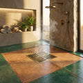 Close-up of InArt antique brass floor drain cover, easy clean removable grate for bathroom floor