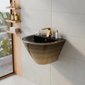 Small wash basin wall mounted for compact bathroom, black ceramic basin with gold stripes, close-up finish