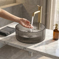 Close-up of glossy black tempered glass table top wash basin rim, premium finish for washroom vanity