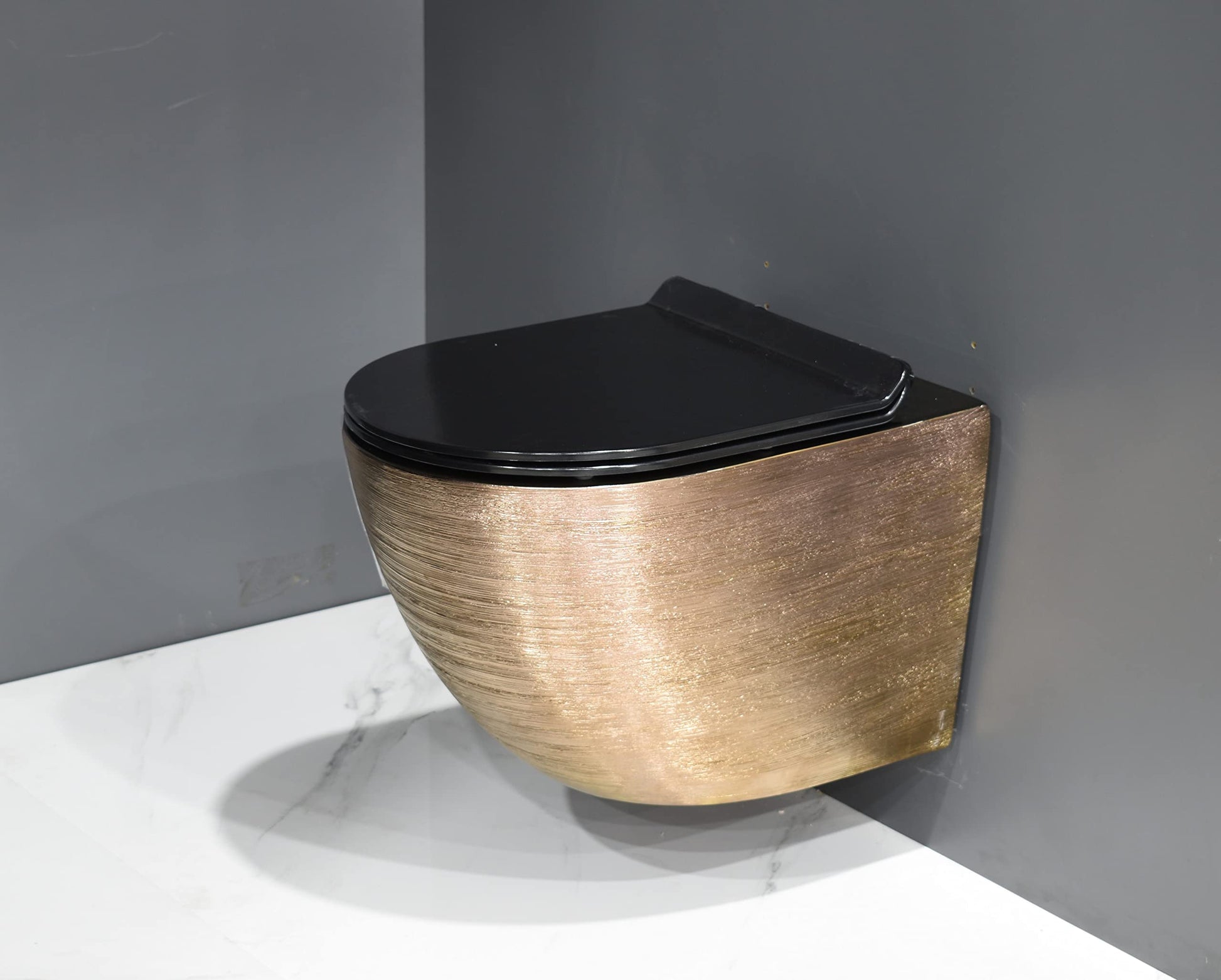 Close-up of InArt soft close toilet seat cover on rose gold rimless wall mounted ceramic commode for bathroom