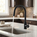 Close-up of InArt black kitchen sink mixer handle and matte black coating on stainless steel body