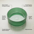 Designer glass table top wash basin in green tinted glass, round bowl, angled view for modern bathroom