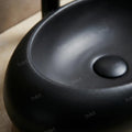 Rectangular table top wash basin in matte black ceramic, smooth rim and deep bowl detail for washroom vanity