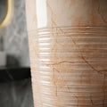 Dining room wash basin area design idea featuring a round ceramic pedestal wash basin in orange marble finish